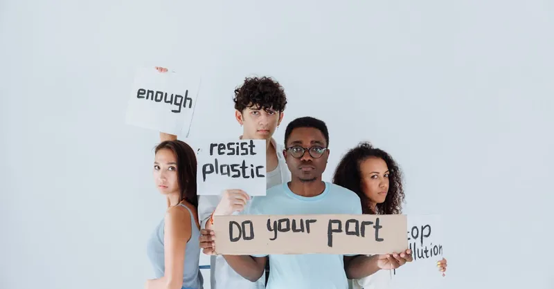 Diverse group of young activists holding signs at an environmental protest, conveying messages of change.