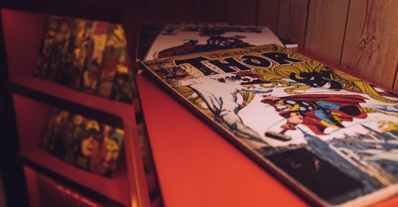 Close-up of a vintage Thor comic book displayed in an art gallery or store.