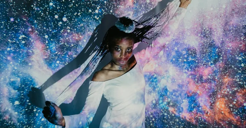 Artistic portrait of a woman in front of a cosmic backdrop, embracing celestial themes.